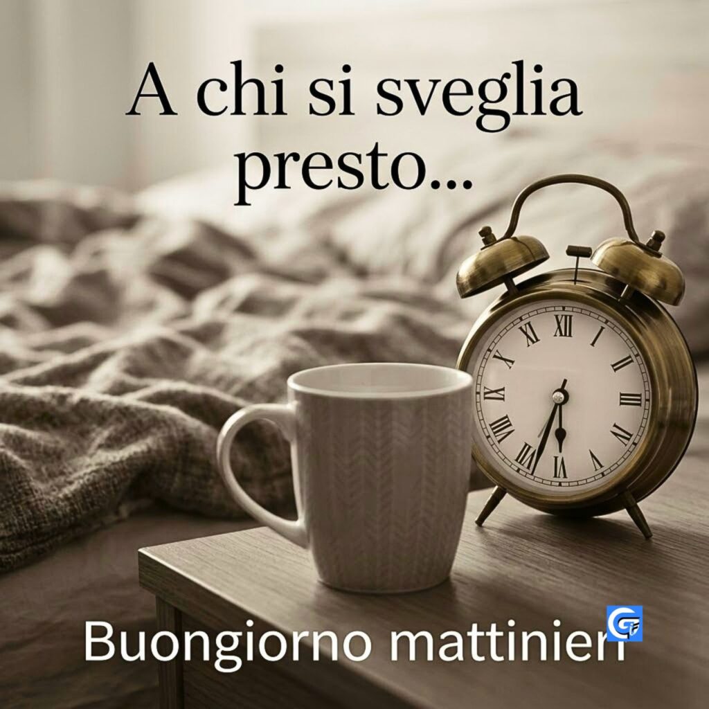 Tazza e sveglia vintage su comodino con scritte 'A chi si sveglia presto... Buongiorno mattinieri'.